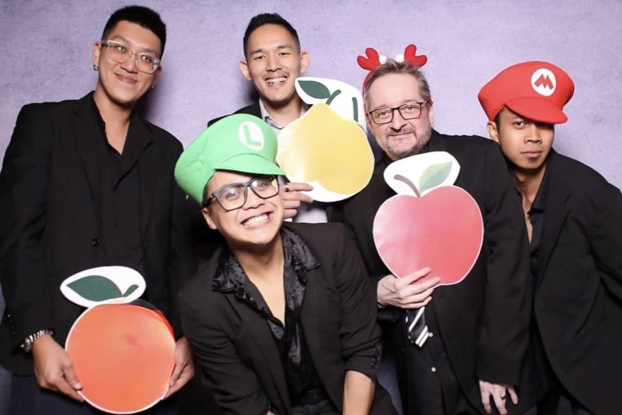 The Jukuleles having fun at a wedding photo booth