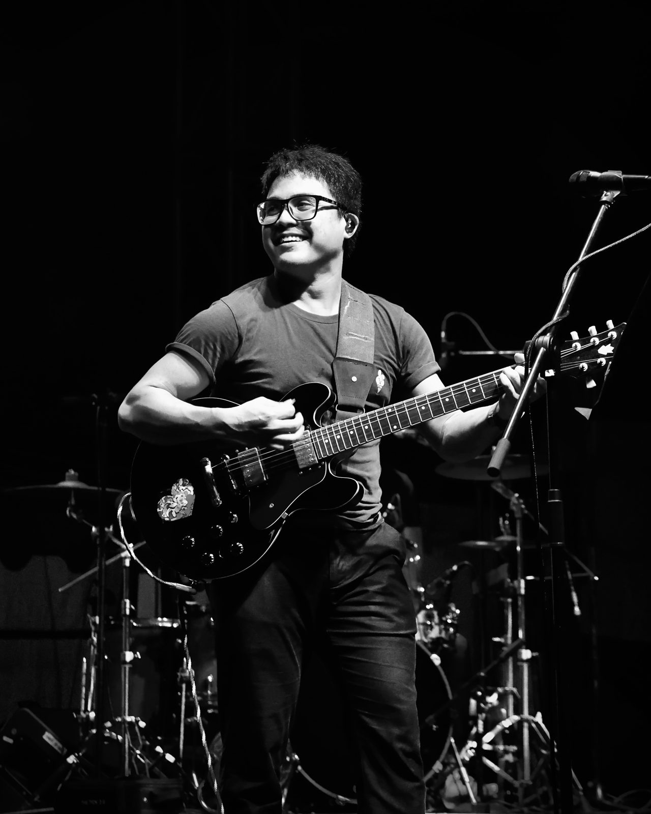 Guitarist performing on stage in black and white